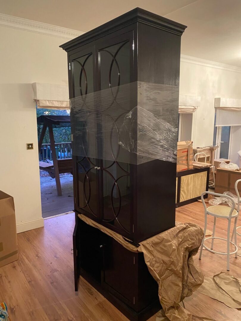 A black cabinet sitting in the middle of a room.
